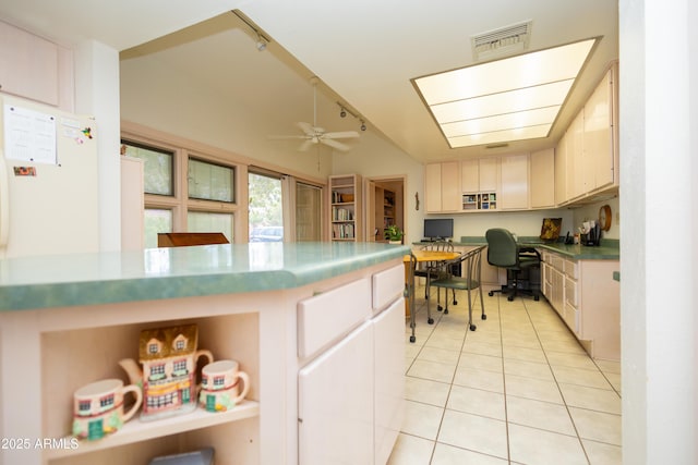1565 E 12th St, Douglas, AZ 85607 - kitchen with built in desk, light tile patterned floors, a ceiling fan, vaulted ceiling, and rail lighting
