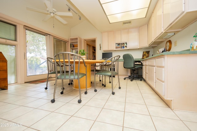 1565 E 12th St, Douglas, AZ 85607 - kitchen featuring ceiling fan, vaulted ceiling, light tile patterned flooring, and white cabinets