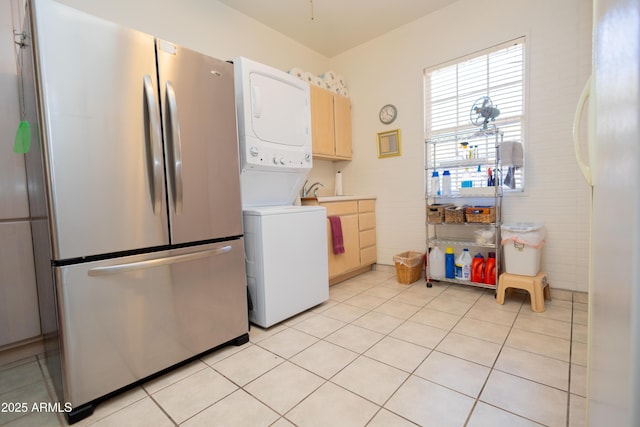 1565 E 12th St, Douglas, AZ 85607 - kitchen featuring freestanding refrigerator, estacked washer and dryer, and light tile patterned floors