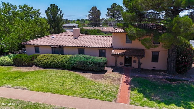 1565 E 12th St, Douglas, AZ 85607 - mediterranean / spanish-style house featuring a tile roof, stucco siding, a front yard, and a chimney