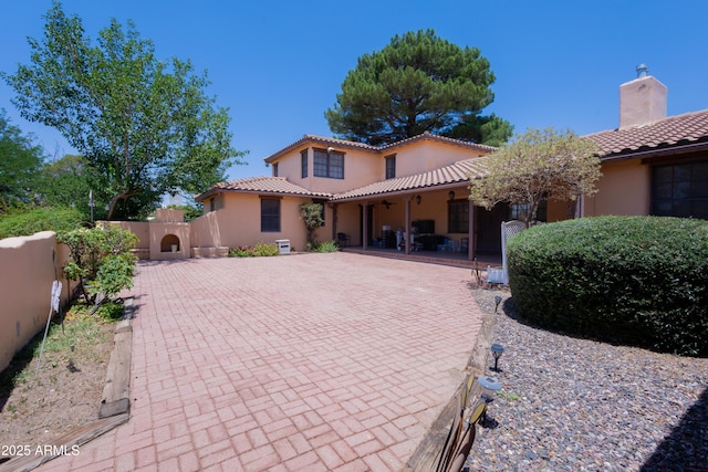 1565 E 12th St, Douglas, AZ 85607 - mediterranean / spanish home with stucco siding, a tiled roof, a chimney, and a patio