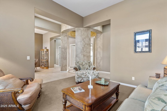 carpeted living room featuring ornate columns