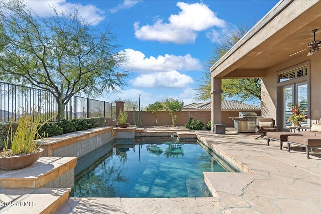 view of swimming pool with grilling area, a patio area, and ceiling fan