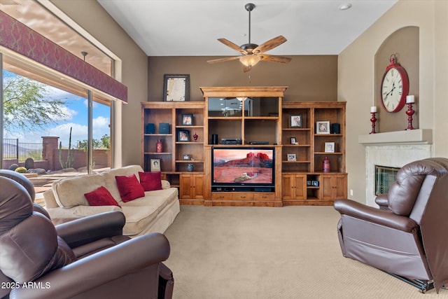 carpeted living room with ceiling fan