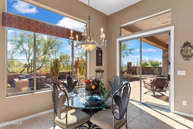 dining room featuring light tile patterned floors and a chandelier