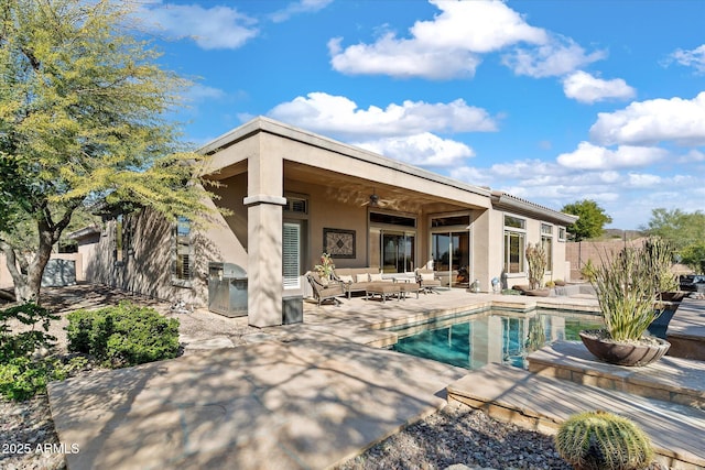 rear view of house featuring outdoor lounge area, a patio, and ceiling fan