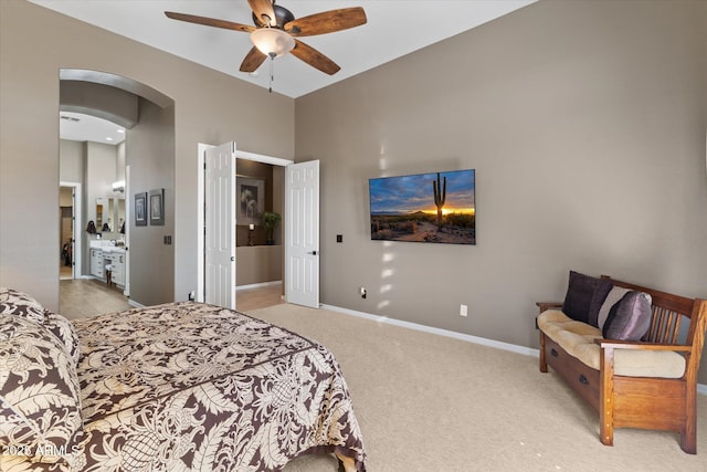 bedroom featuring ceiling fan, light carpet, and a high ceiling