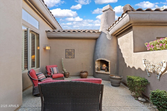 view of patio / terrace featuring an outdoor fireplace