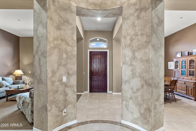 tiled foyer entrance featuring a high ceiling