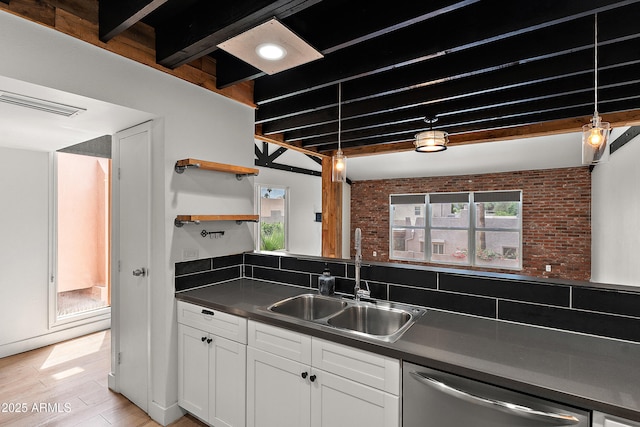 5621 N 79th St, Scottsdale, AZ 85250 - kitchen featuring stainless steel dishwasher, a sink, white cabinets, dark countertops, and light wood-style floors