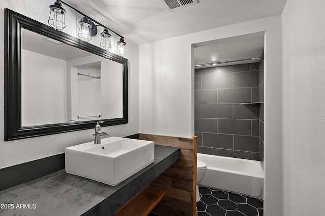 5621 N 79th St, Scottsdale, AZ 85250 - bathroom with toilet, tile patterned floors, vanity,  shower combination, and a textured wall