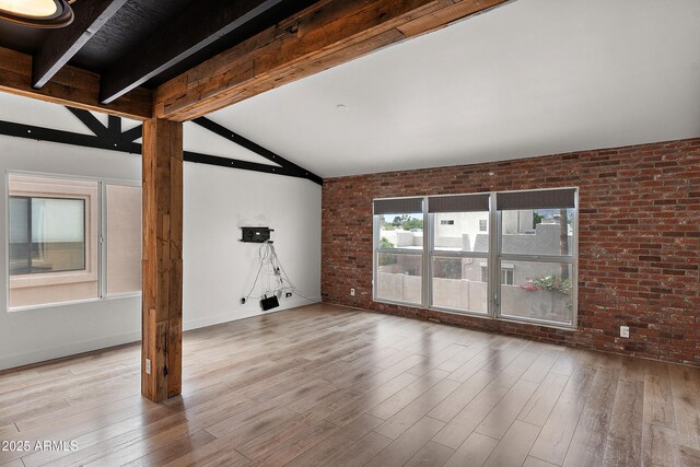 5621 N 79th St, Scottsdale, AZ 85250 - unfurnished living room featuring brick wall, wood finished floors, and baseboards