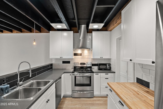 5621 N 79th St, Scottsdale, AZ 85250 - kitchen featuring stainless steel appliances, wall chimney range hood, a sink, wood counters, and decorative backsplash