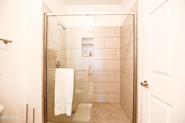 full bath with toilet and a stall shower