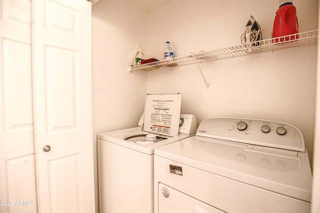 washroom featuring washer and clothes dryer and laundry area