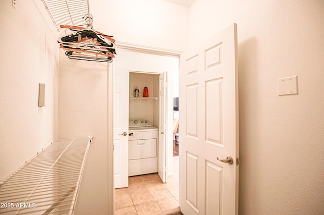 spacious closet featuring washer / clothes dryer and light tile patterned flooring