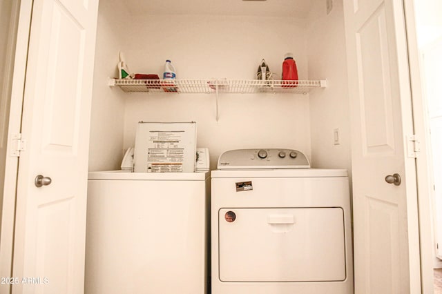 laundry area featuring washing machine and clothes dryer and laundry area