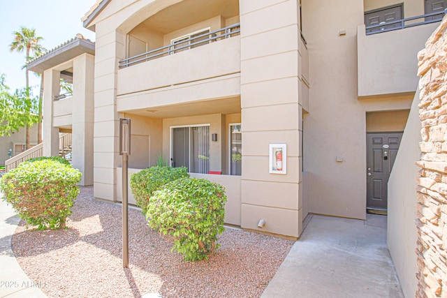 entrance to property with stucco siding