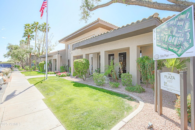 view of front of house featuring a front yard and stucco siding