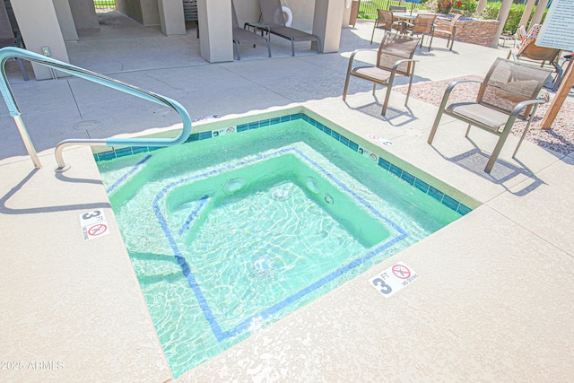 view of pool with a patio area and a community hot tub
