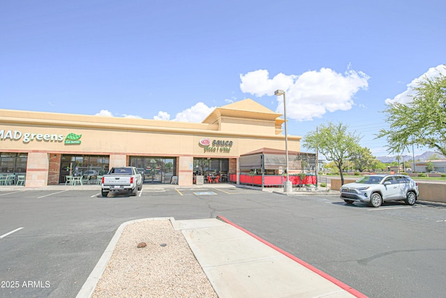 view of building exterior featuring uncovered parking