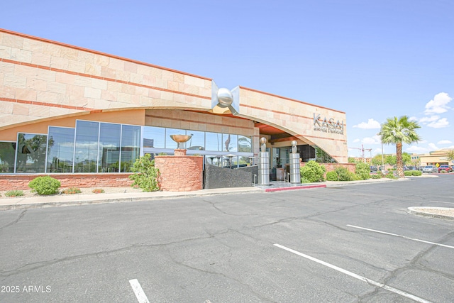 view of building exterior with uncovered parking
