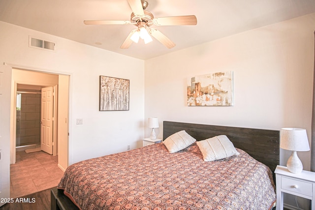 bedroom with tile patterned floors, visible vents, baseboards, and ceiling fan