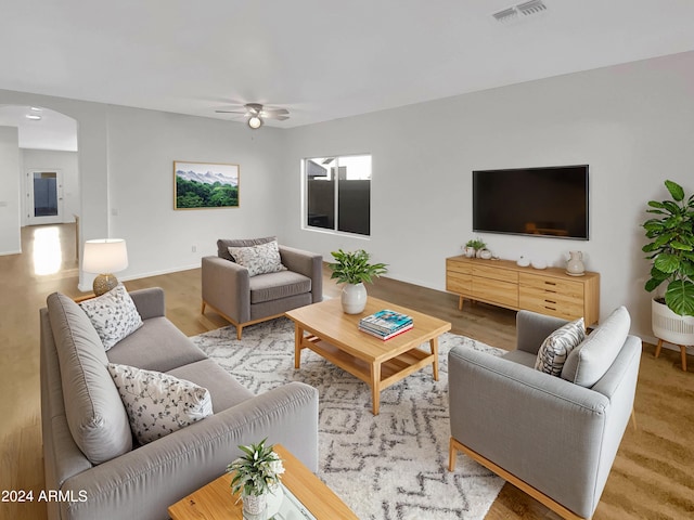 living room featuring ceiling fan and hardwood / wood-style flooring