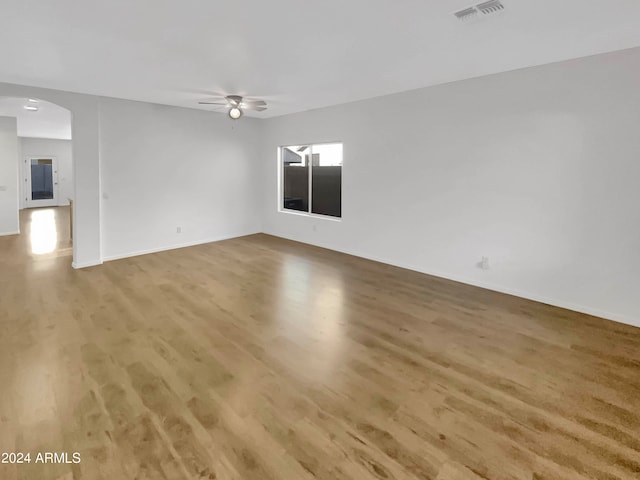 empty room with ceiling fan and wood-type flooring