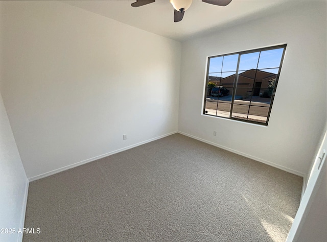 empty room featuring carpet flooring and ceiling fan