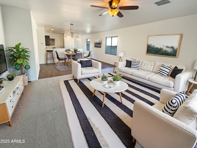 living room featuring ceiling fan and hardwood / wood-style floors