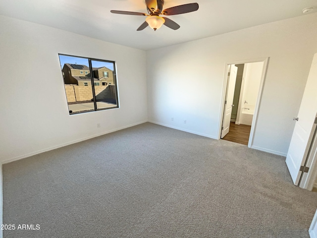 carpeted empty room featuring ceiling fan