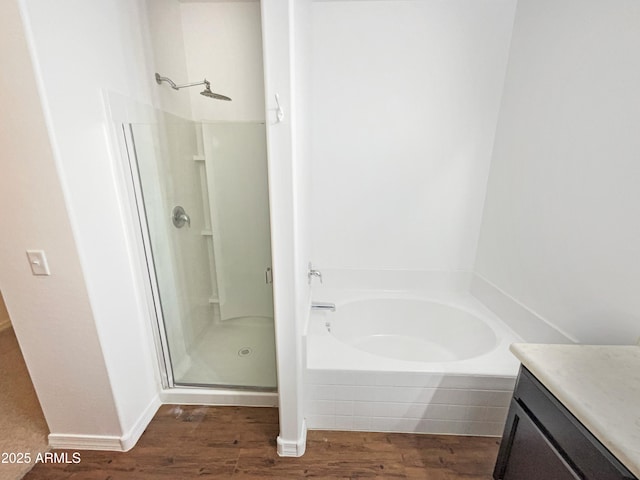 bathroom with vanity, hardwood / wood-style floors, and separate shower and tub