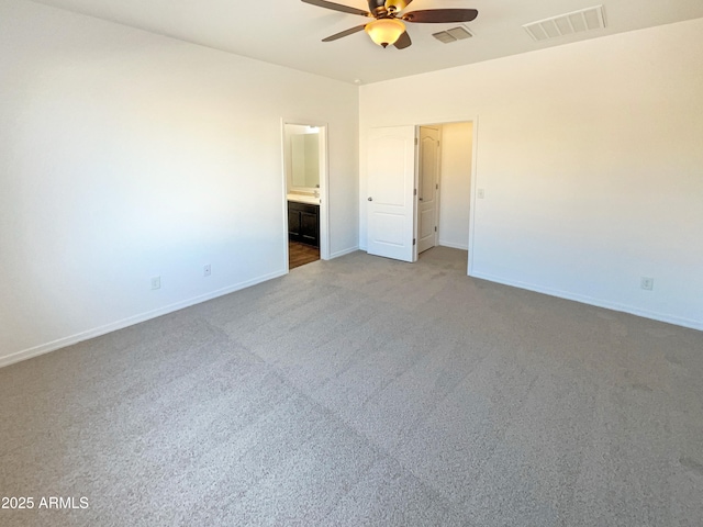 spare room with light colored carpet and ceiling fan