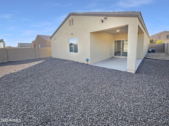 rear view of house with a patio and central air condition unit