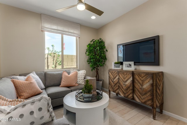 living area featuring baseboards, a ceiling fan, and recessed lighting