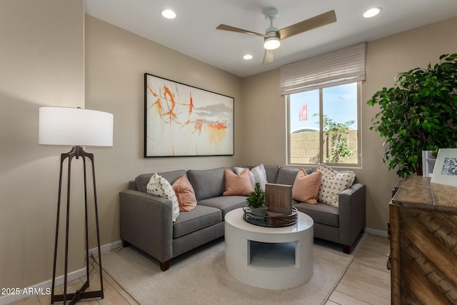 living room featuring ceiling fan, light wood-style flooring, baseboards, and recessed lighting
