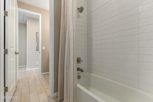full bathroom featuring shower / bathtub combination with curtain and baseboards