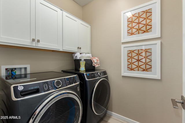 washroom featuring cabinet space, baseboards, and independent washer and dryer