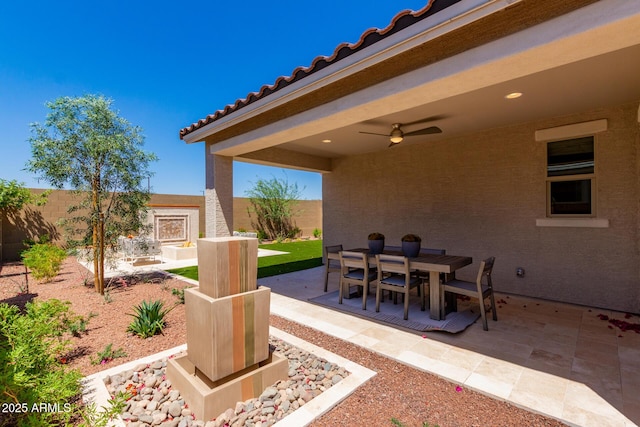 view of patio featuring a fenced backyard, ceiling fan, and outdoor dining space