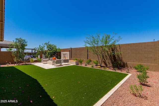 view of yard featuring an outdoor hangout area, a patio area, and a fenced backyard