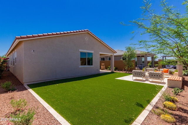back of house featuring a patio, a tiled roof, stucco siding, fence, and an outdoor hangout area