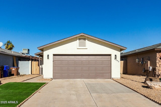 single story home featuring a garage, central AC unit, and an outdoor structure