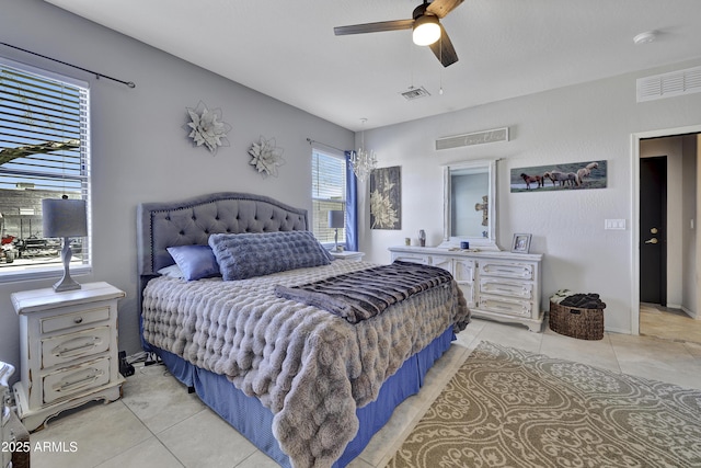 bedroom featuring light tile patterned floors, ceiling fan, and visible vents