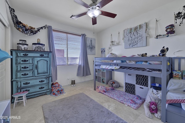 tiled bedroom with a ceiling fan