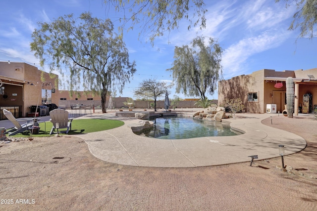 surrounding community featuring a pool, a patio area, and fence