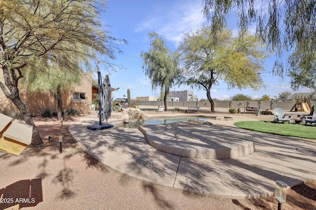 view of home's community with a swimming pool, a patio area, and fence