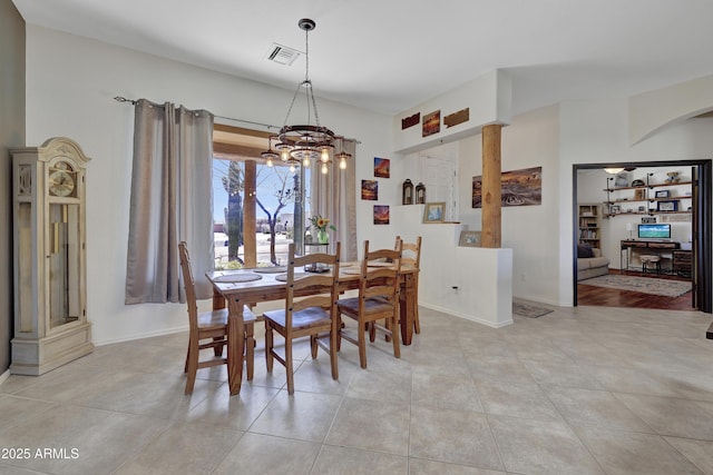 dining area featuring a chandelier, visible vents, baseboards, and light tile patterned floors