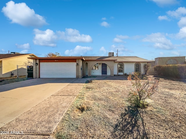 single story home featuring central air condition unit and a garage