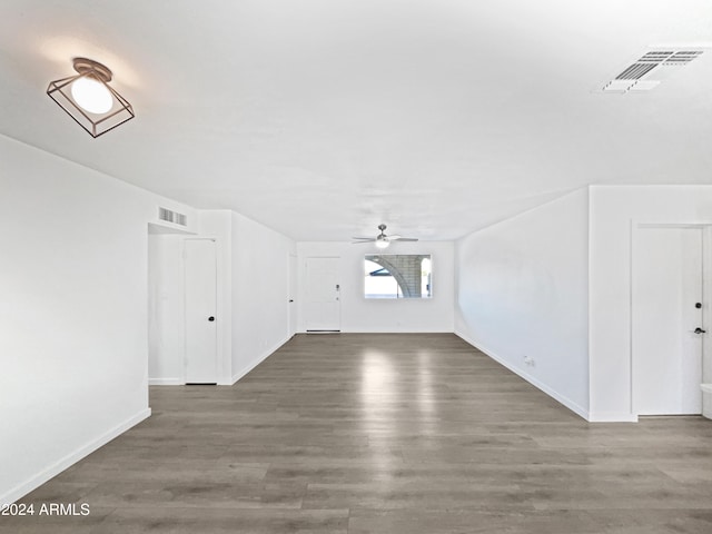 bonus room with dark wood-type flooring and ceiling fan